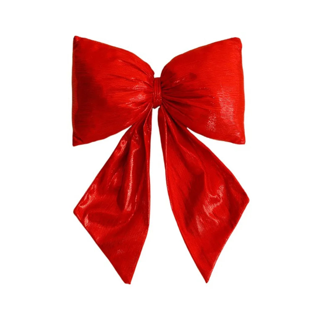 Decorazione natalizia con fiocchi rossi di grandi dimensioni per la punta dell'albero.