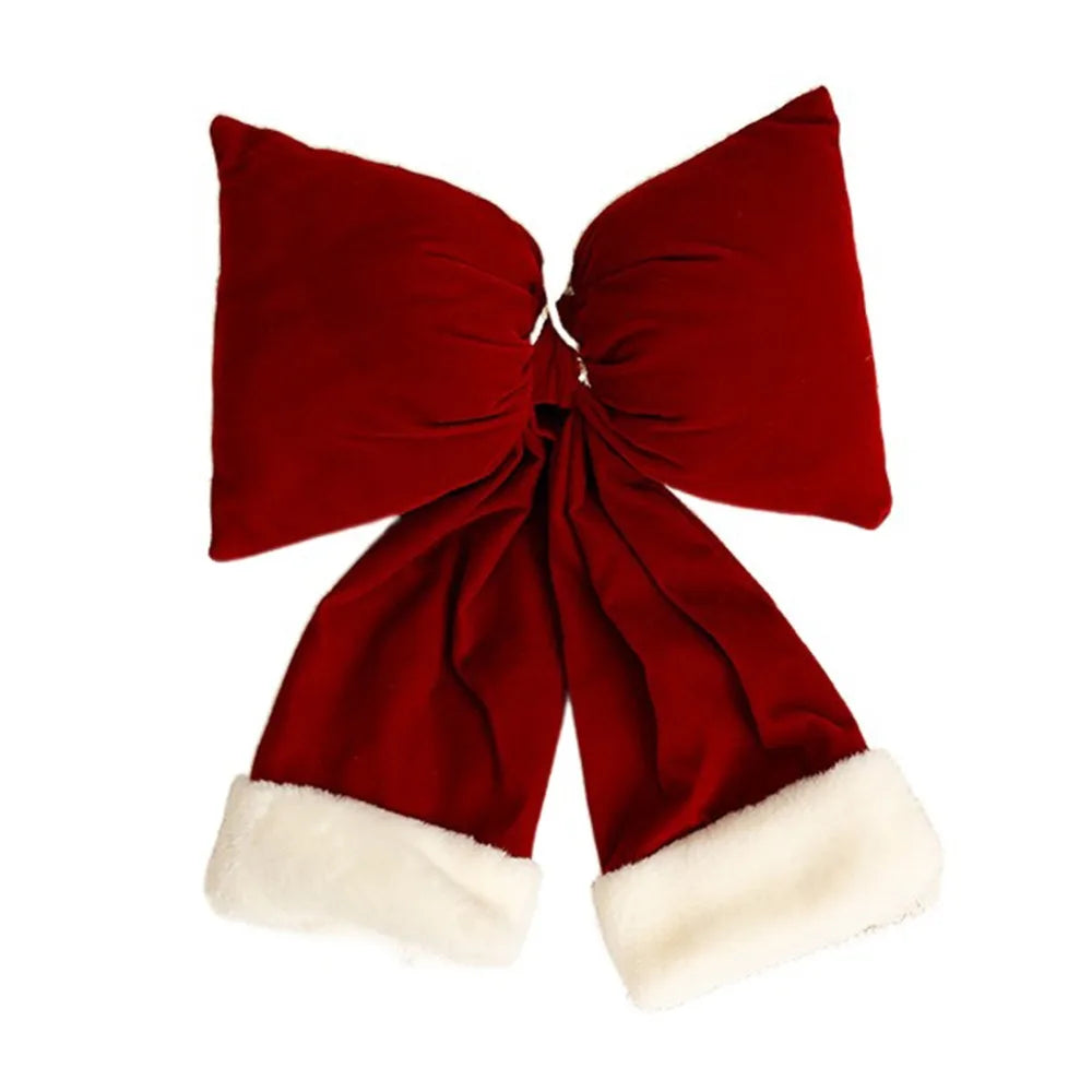 Decorazione natalizia con fiocchi rossi di grandi dimensioni per la punta dell'albero.